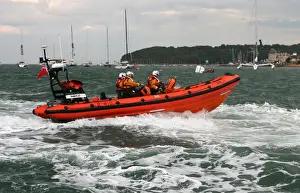Cowes Atlantic 85 inshore lifeboat Tabbycat B-810 moving from left to right at speed during a demonstration at Cowes Week