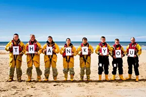 Crew members at Rhyl holding up letters spelling out the words Thank You. Left to right: Paul Frost MBE (Deputy 2nd coxswain / LPO), Derek Denton (Tractor drive / ALB crew), Bob Baines (Tractor driver / ALB crew), Tina Elliot (ALB crew)