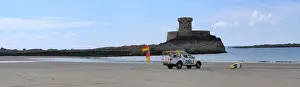 Lifeguards monitoring the sea at a beach in Jersey from within a lifeguard patrol vehicle. Panoramic shot