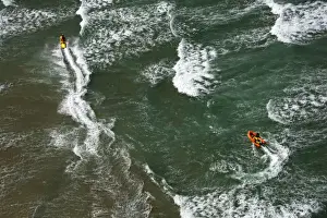 Lifeguards on a rescue watercraft (RWC) and arancia inshore rescue boat shot from Culdrose helicopter in St Ives