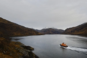 Mallaig severn class lifeboat Henry Alston Hewat 17-26 at sea, snow capped mountains