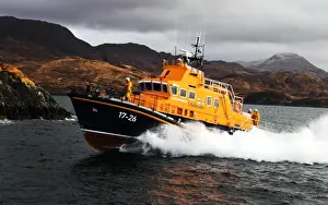 Mallaig severn class lifeboat Henry Alston Hewat 17-26. Lifeboat in the distance moving from right to left, hills and cliffs behind