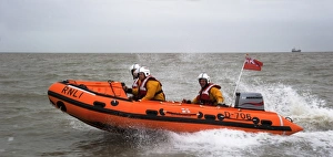 Margate D-class inshore lifeboat Tigger Three D-706. Lifeboat moving from right to left, three crew on board Margate D-class inshore lifeboat Tigger Three D-706. Lifeboat moving from right to left, three crew on board