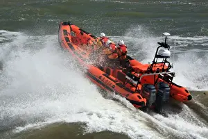 Minehead Atlantic 85 inshore lifeboat Richard and Elizabeth Deaves B-824. Lifeboat heading from away from the camera, four crew on board, lots of white spray