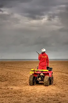 RNLI lifeguard on a quad bike patrol vehicle at Skegness beach