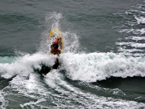 An RNLI lifeguard on a rescue water craft at Perranporth