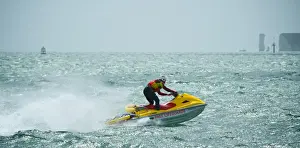Life Guard Prints: RNLI lifeguard on a rescue watercraft off Sandbanks beach