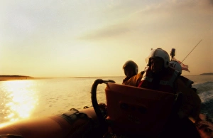 <b class=qtipBold><figcaption>Sunset from the lifeboat</figcaption></b><br>Sunset from the lifeboat. 3 crew members visible. Calm seas. Boat to the right side of the picture<br><em>© Nigel Millard</em> Sunset from the lifeboat