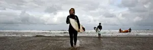 Life Guard Prints: Two surfers walking in from the sea towards the camera