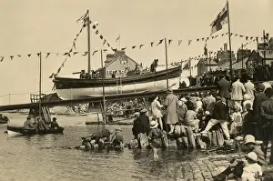 Swanage motor lifeboat Thomas Markby being launched down the slipway, crowds of people gathered on the shore. Black and white photo taken in 1928