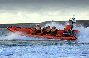 Trearddur Bay Atlantic 85 inshore lifeboat Hereford Endeavour B-847. Lifeboat moving from right to left at speed, foud crew on board