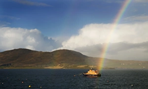 Valentia severn class lifeboat John and Margaret Doig 17-07. Lifeboat is moored in the harbour with a rainbow directly Valentia severn class lifeboat John and Margaret Doig 17-07. Lifeboat is moored in the harbour with a rainbow directly